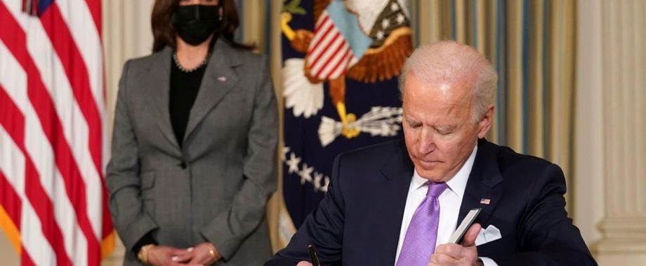 biden signing papers harris.jpg